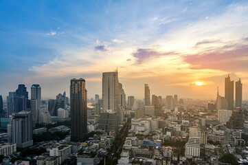 Fototapeta na wymiar Cityscape of modern buildings and urban architecture. Aerial view of Bangkok city at twilight sunset in Thailand.