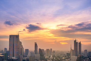 Naklejka na ściany i meble Cityscape of modern buildings and urban architecture. Aerial view of Bangkok city at twilight sunset in Thailand.