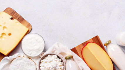 Dairy products frame on light gray background, top view.