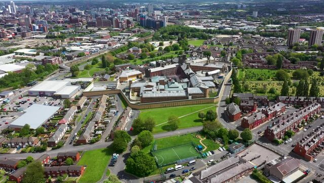 Aerial drone footage of the town of Armley in Leeds West Yorkshire in the UK, showing the famous HM Prison Leeds, or Armley Prison, showing the Jail walls from above on a sunny summers day.