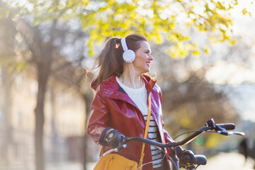 smiling female listening to music outside in city