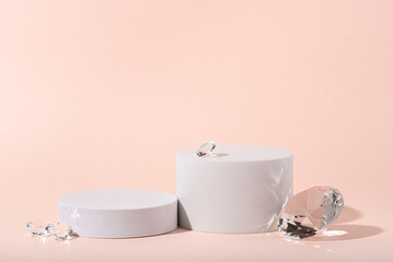 White podium with diamonds on a pink background.