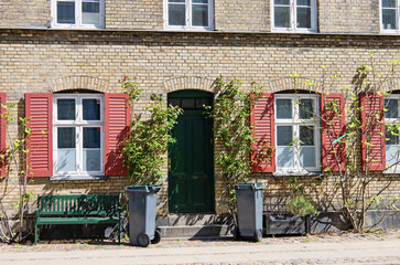 Naklejka premium House facades in Copenhagen, Denmark. Entrance to old house in Copenhagen. Real estate investment. Expensive housing in the center of the city.