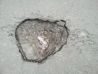 Funnel in the asphalt after the explosion, top view.
