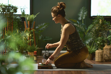 stylish housewife in modern green living room