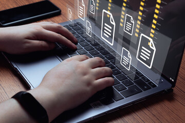 Woman use laptop with virtual holographic interface of documents. Document Management System (DMS) concept. Process automation to efficiently manage files. 