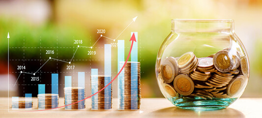 Stack of Coins with growing income profit graph and glass jar. Investing coin step, investment,...