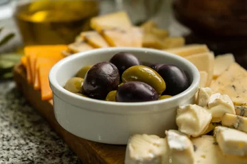 Foto op Plexiglas Close-up of green and black olives with cheese varieties © Kevin