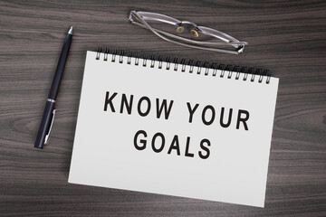 Know your goals text on notepad with pen, notepad and reading glasses.