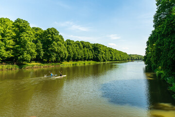 View from the Sachsenbrücke at the Clara-Zetkin-Park in Leipzig, canoeists train on the river