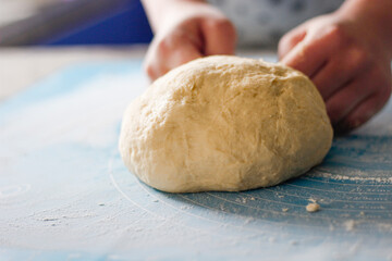 Woman's hands making dough for baking