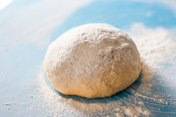 Rising or proofed yeast dough for bread or pizza on a floured surface