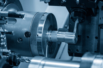 The multi-tasking CNC lathe machine swiss type milling cut the metal parts by milling spindle.