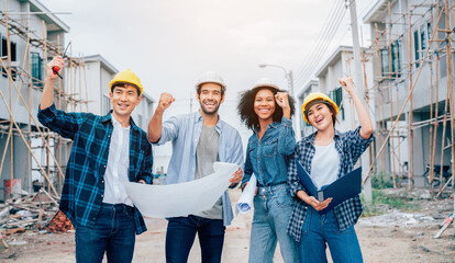 Group of engineers construction and workers raise their hand after achieve their mission or construction. Success collaboration concept.