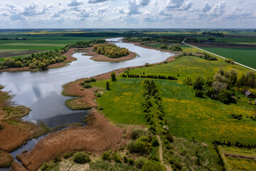 Fototapeta na wymiar Beautiful panoramic aerial view of the countryside with a pond and agricultural fields