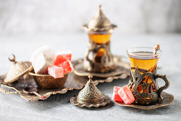 Black tea in Turkish glasses armudu and lokum. Eastern Tea Ceremony