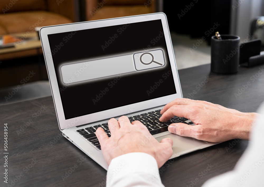 Aufkleber Businessman working on laptop and searching information on Internet. Screen with search bar icon. Man hands at keyboard closeup typing keywords. High quality photo