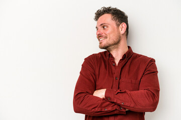 Young caucasian man isolated on white background smiling confident with crossed arms.