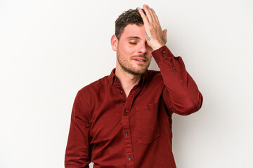 Young caucasian man isolated on white background forgetting something, slapping forehead with palm and closing eyes.