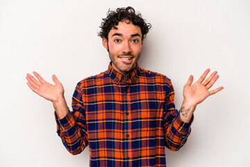 Young caucasian man isolated on white background confused and doubtful shrugging shoulders to hold...