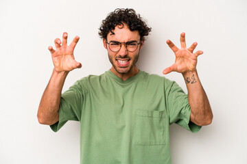 Young caucasian man isolated on white background upset screaming with tense hands.