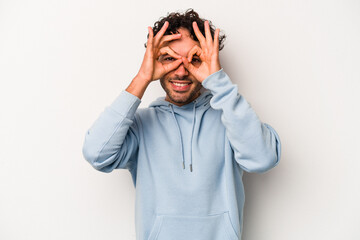 Young caucasian man isolated on white background excited keeping ok gesture on eye.