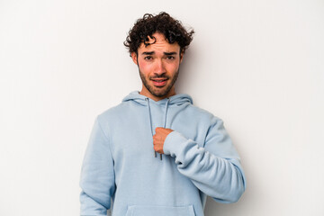 Young caucasian man isolated on white background surprised pointing with finger, smiling broadly.