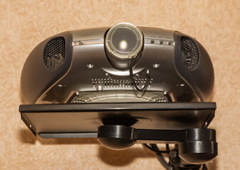 Projector close-up on the background of the wallpaper of the room wall