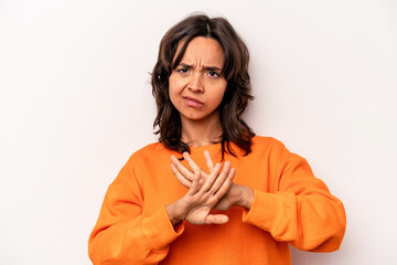 Young hispanic woman isolated on white background standing with outstretched hand showing stop...