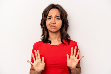 Young hispanic woman isolated on white background rejecting someone showing a gesture of disgust.
