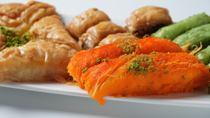 A tray of Turkish pastries including baklava, knafeh -  a Middle Eastern cheese pastry soaked in sweet, sugar-based syrup