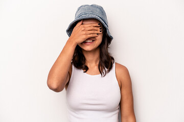 Young hispanic woman isolated on white background covers eyes with hands, smiles broadly waiting for a surprise.