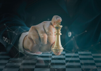 Hand of businessman holding the golden king chess to fighting silver king chess to play successfully in the competition with technology network background. Management or leadership strategy concept.