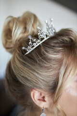 Luxury wedding crown diadem on bride's head hairstyle. morning wedding preparation bride with crown...