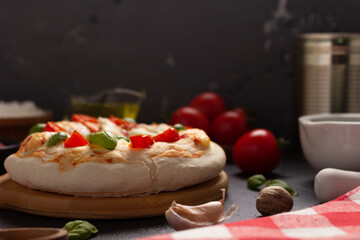 Italian pizza with ingredients on table. Pizza cooking at tabletop background