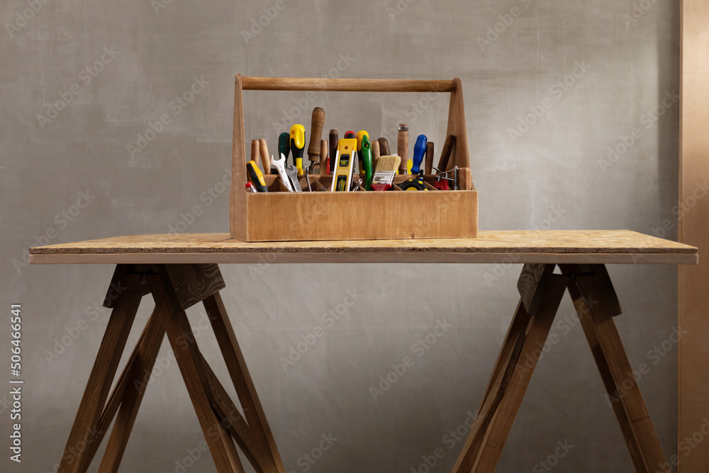 Wall mural construction tools and toolbox at wooden table background texture. tools kit and tool box