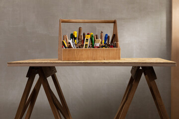 Construction tools and toolbox at wooden table background texture. Tools kit and tool box