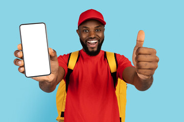 Great App. Black Delivery Guy Holding Blank Smartphone And Showing Thumb Up