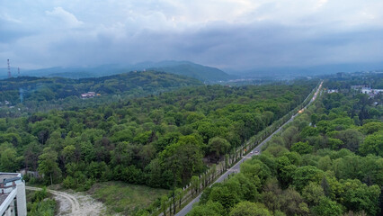 Fototapeta na wymiar Shooting from a quadcopter. Top view, flat landscape. Forest, park, tree, hills, village, city, road. Bird's-eye.