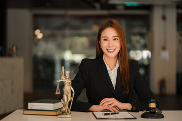 Attractive Asian Lawyer Female Lawyer Discussing Contract Documents with Golden Goddess Scales with...