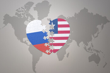 puzzle heart with the national flag of russia and liberia on a world map background. Concept.