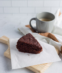 Chocolate cake and a cup of Coffee on a wooden tray. Closeup picture