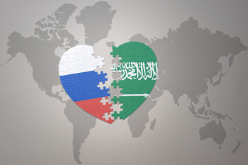 puzzle heart with the national flag of russia and saudi arabia on a world map background. Concept.