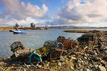 Landscape image showing fishing boats and industry at South Gare on Teesside near Middlesbrough,...