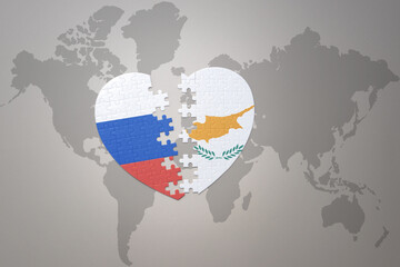 puzzle heart with the national flag of russia and cyprus on a world map background. Concept.