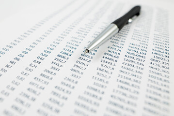 The concept of analysis, statistics. Close-up of a pen on a paper sheet with numbers.