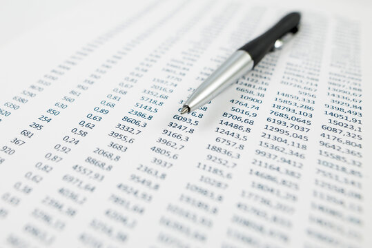 The concept of analysis, statistics. Close-up of a pen on a paper sheet with numbers.