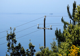 An electric pole along a coastline