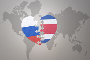 puzzle heart with the national flag of russia and costa rica on a world map background. Concept.