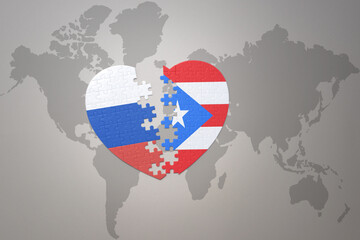 puzzle heart with the national flag of russia and puerto rico on a world map background. Concept.